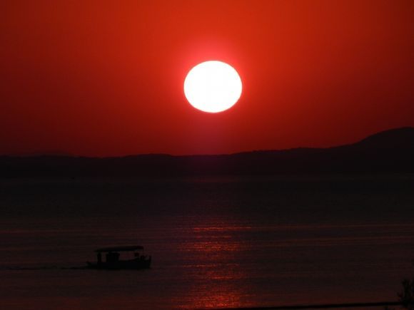 A fishing boat at sunrise in Salonikiou Beach....