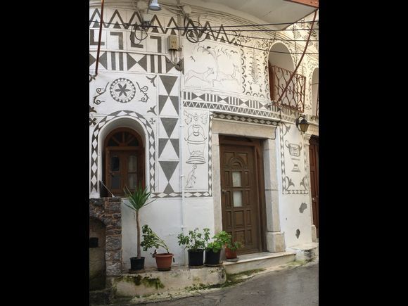 I am in Pyrgi one of several mastic villages. This village is the only one in Greece with these painted walls. The craft is called xysta, meaning scratched as the design is drawn into the surface of plaster and lime and then colored. 