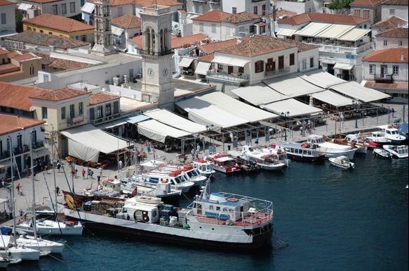 Overview of the beautiful harbor on Hydra. Here the supply boat has arrived with goods and the cafes along the harbor promenade are ready for today's guests.