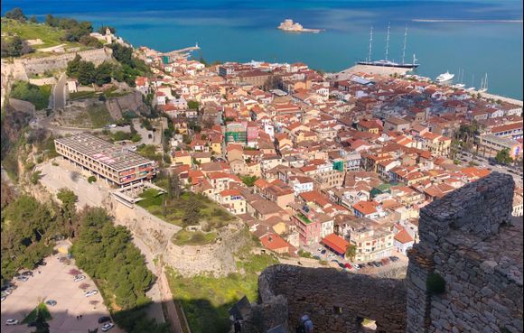 View from Palamidas Castel towards the beautiful old town of Nafplio. The building in the middle of the picture is a disgrace to the city, an ugly ruin of an old hotel, on the city's best plot. (april 2022)