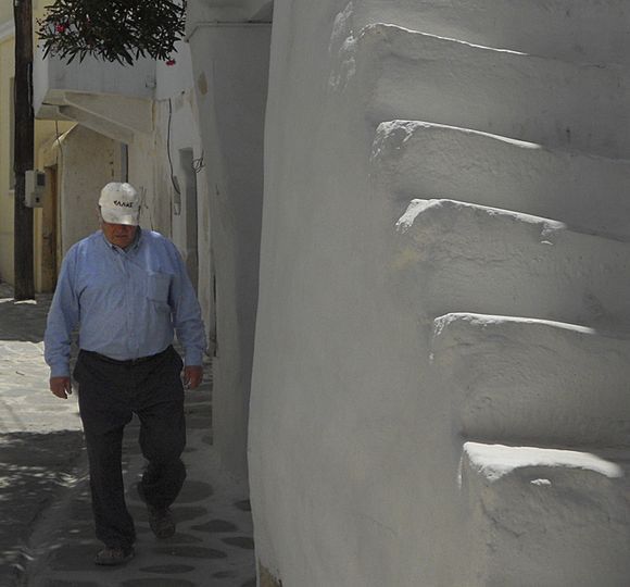 Man walking by stairs in old town of Parikia.
