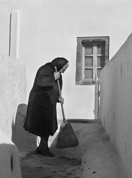 Woman sweeping sidewalk in Pyrgos