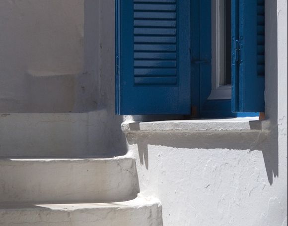 Blue shutter and steps in Naxos old town.