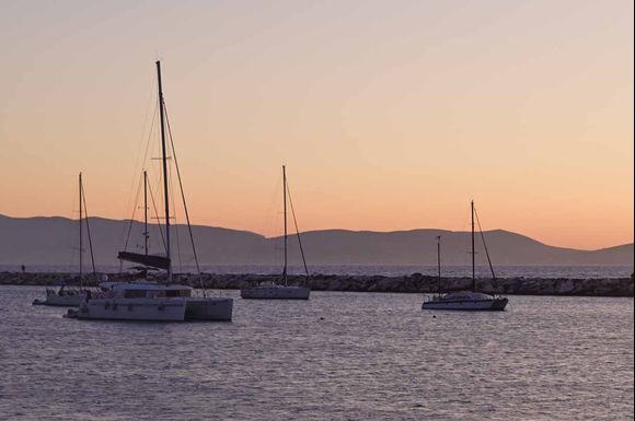 Sailboats, under pastel setting sun