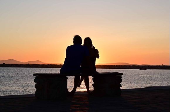 Sun setting, lovers in silhouette along Ariadnis