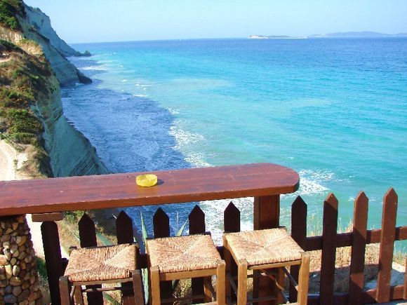 Take your time, sitdown, enjoy the great view here in Peroulades - look to the cliffs of Logas Beach.