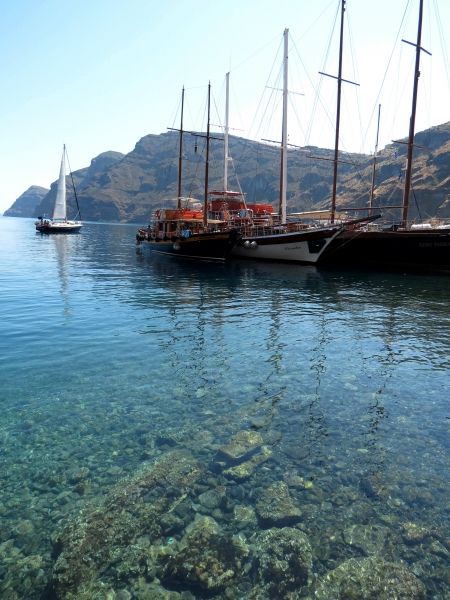 Boats on the clear waters of ormos Korfou, Therasia
