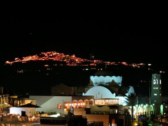 Good Friday night. View to Pyrgos. The whole hillside is lit up by burning cressets. Some of them are lined up in the shape of a cross.