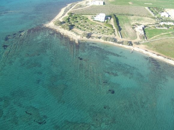 Human made enormously long structures in shallows, shot from helicopter.