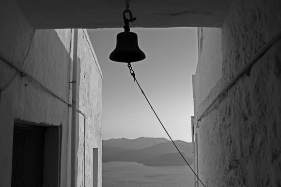 A calm sea awaits the sunset and the toll of the bell from the church above Plaka