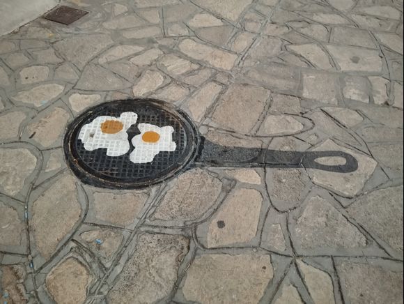 Fried eggs on a manhole cover , The Blue Street in Pythagorio 