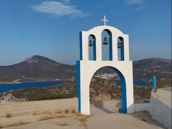 THIMENA island. Agios Nikolaos church, you can spot  the white houses of Fourni's main town between the arcade.