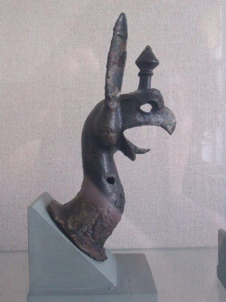 Bronze griffin, ornament from a cauldron, retrieved from the Heraion. These functioned as common votives to the goddess Hera. (August 2015)