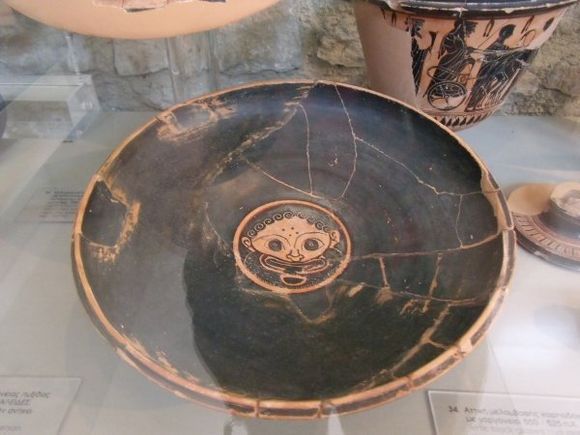 Kylix depicting the head of a Gorgon, displayed in the archaeological museum.. (August 2015)