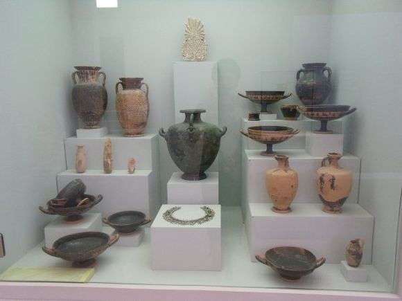 Display primarily showing black-figure and black-glazed pottery, common during Archaic and (early) Classical times. This is but one of many wonderful displays in the archaeological museum. (August 2012)
