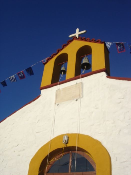 Agia Fotini during the yearly festival in May with Greek flag and Hydra flag