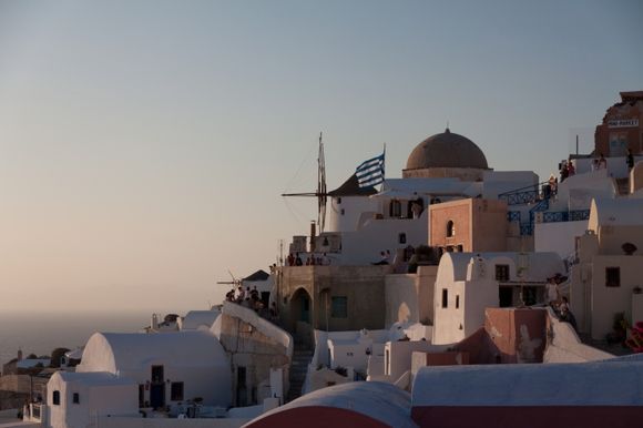 Sunset from Oia. View of the windmill and the sorrunding buildings.