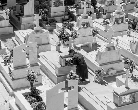 Woman caretaking tombs in a cemetery