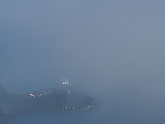 Cape lefkada lighthouse in the fog.