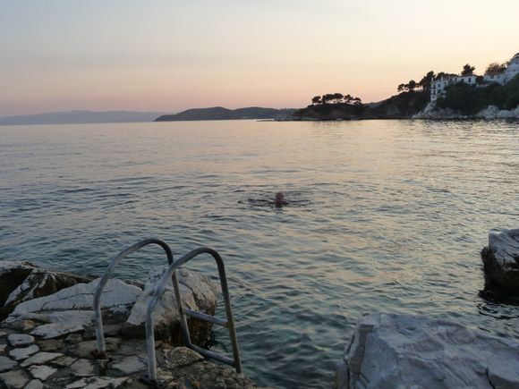 old harbor on Skiathos, swimming on the point at sunset