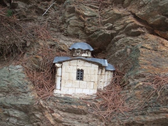 This is a miniature church built in a stone wall.