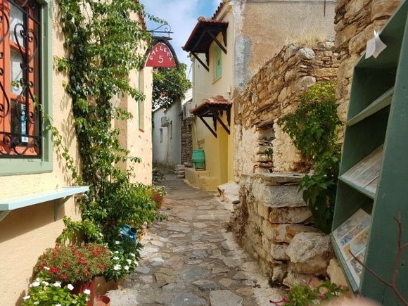 Beautiful view of scenic narrow alley with historic traditional houses and cobbled street in the old town of Chora, Alonissos.