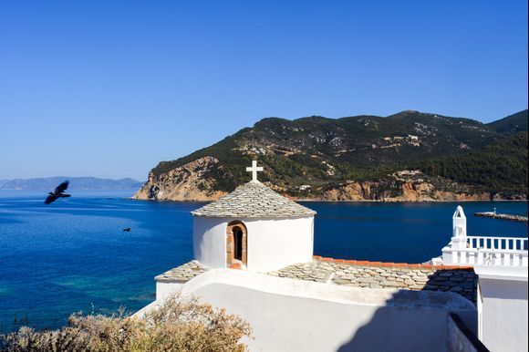 White Orthodox church over the Skopelos bay