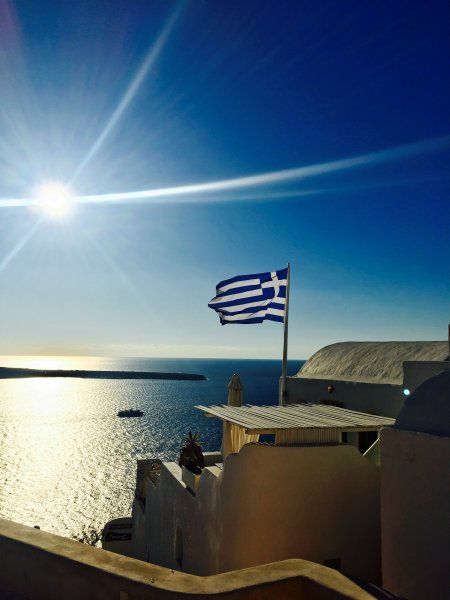 Greece flag over the blue sea