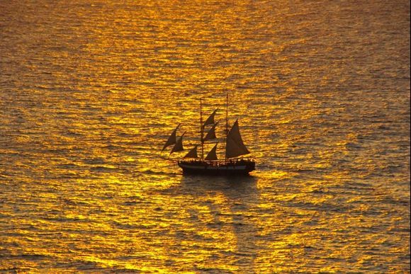 sail boat at sunset in santorini