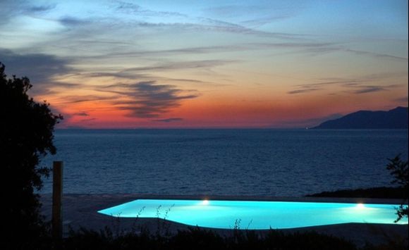 Artificial swimmingpool-lights competing with the sunset