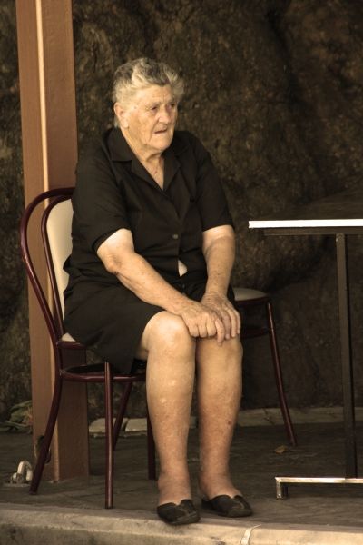 Old woman is relaxing in Theologos