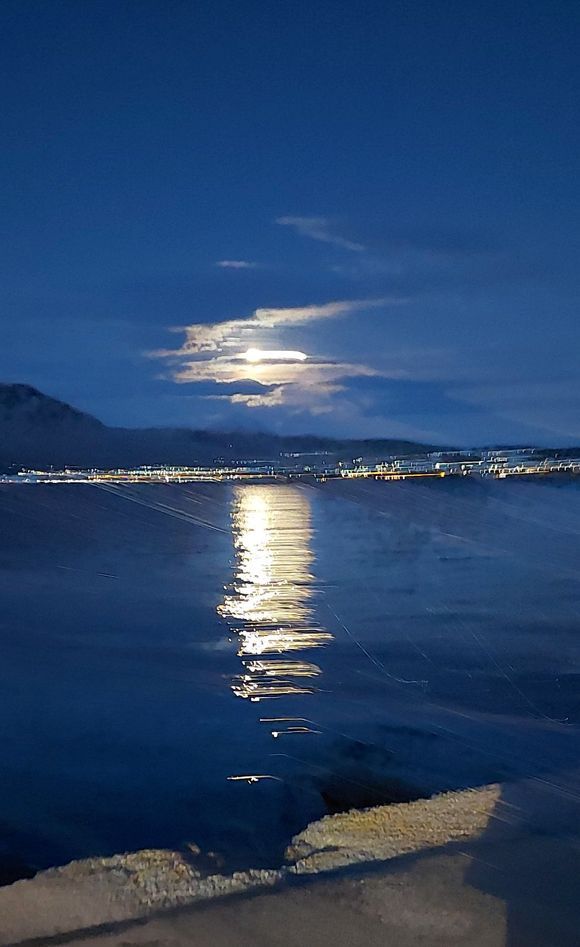 Moonlight over Loutraki Bay and Loutraki in the back.