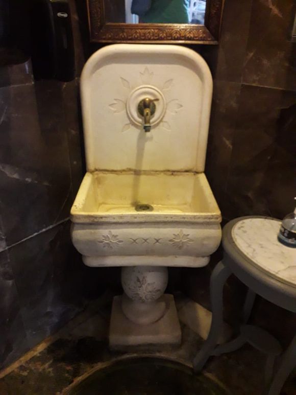 A restaurant uses the original well, as the basin in the restroom. 
