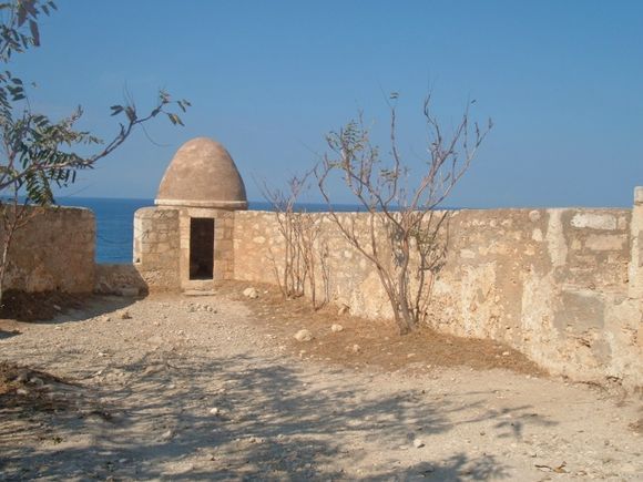 Small stone building at the Fortezza, Rethymno, and view of the sea.