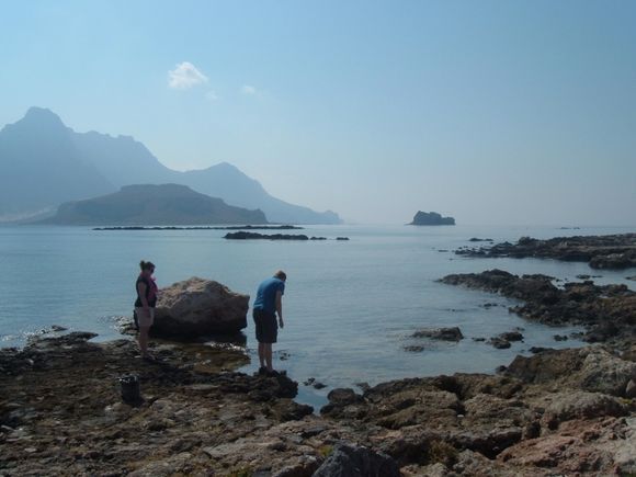 Rock pools at Gramvousa Island with mountains in background.