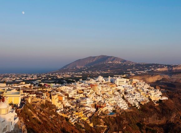 Moon rise over Fira Town, Santorini, Cyclades, Greece.