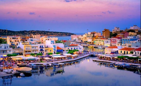 The lake Voulismeni in Agios Nikolaos, a picturesque coastal town with colorful buildings around the port in the eastern part of the island Crete.