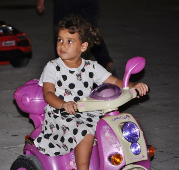 Child playing at night on Solomos square