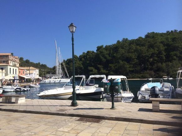Paxi-Gaios port. beautiful place where you can hire boats and visit places like the Blue Caves and the amazing island of Antipaxos with truly the best crystal clear water on the planet! A hidden gem no doubt.