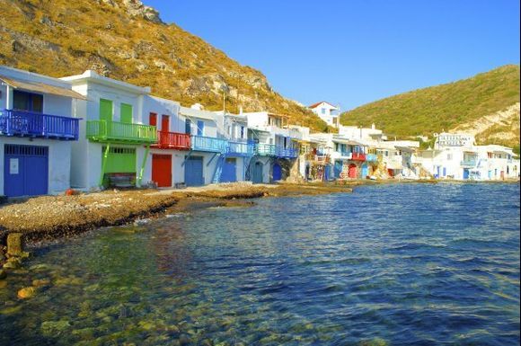 Colourful boathouses that line the seashore at Klima village on Milos island