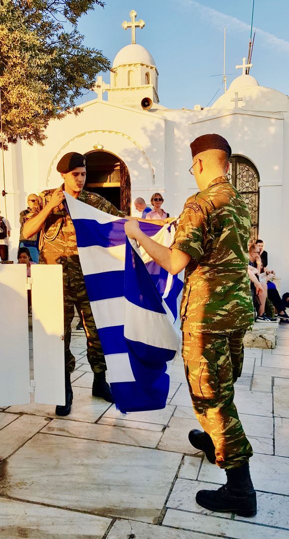 Lowering the flag at sunset on Lycabettus Hill
