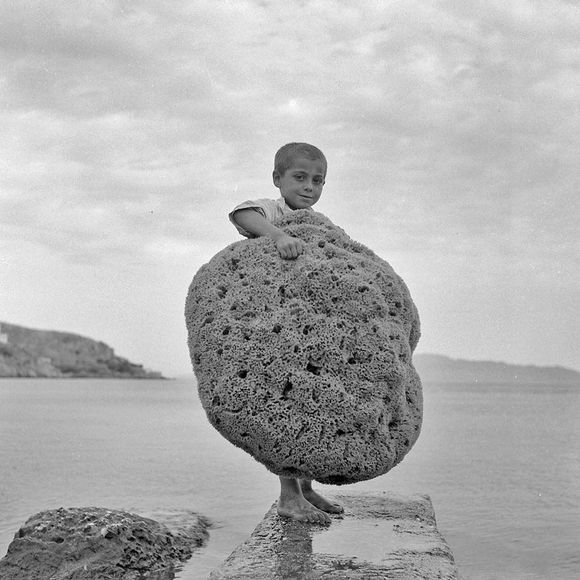 It's throwback Thursday to the 50's on Kalymnos island and to this little guy who proudly poses with a huge natural sea sponge. The island gained big fame worldwide for these amazing products of nature hidden in it's ocean floor. The image was taken by the famous Greek photographer, Dimitris Charisiadis.
Discover Kalymnos on https://www.greeka.com/dodecanese/kalymnos/