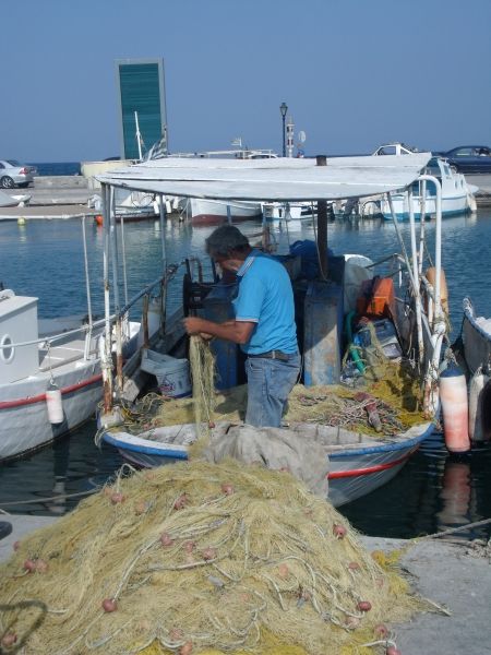 At the port, fisherman, arranging his work tools.
