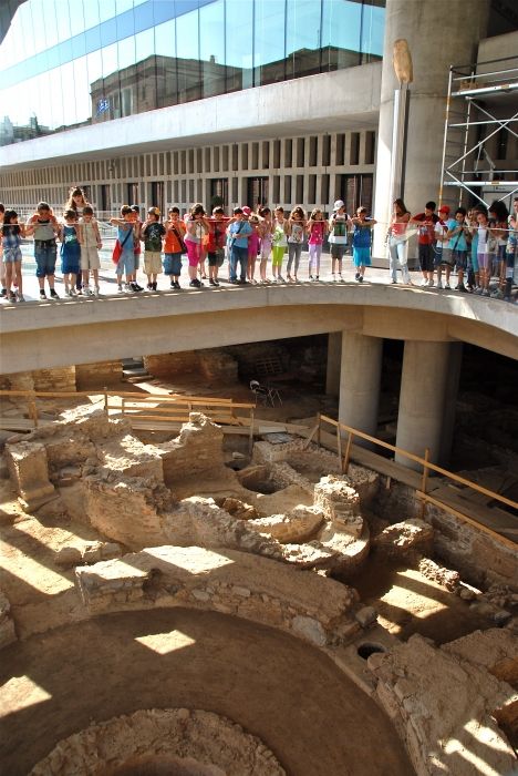 Greek children looking at excavations under Archaeological Museum, Athens.