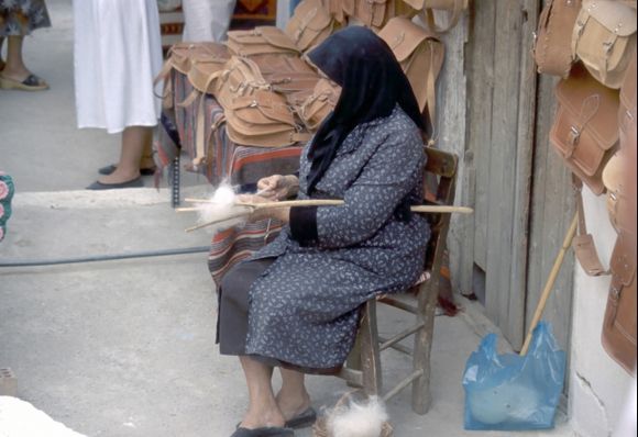 Old woman spinning wool.