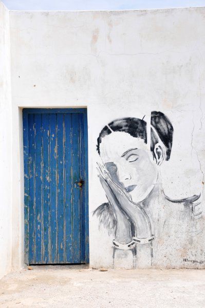 Modern Greek street art on an old house.
