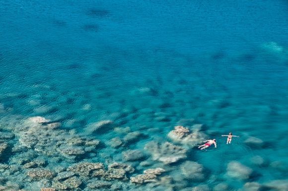 A couple swimming in the amazingly blue and transparent sea of Amorgos.
