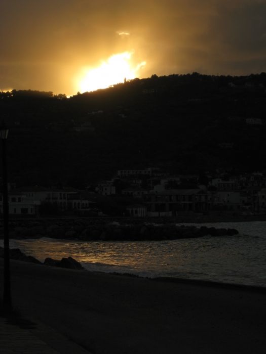 Final moment of sunset over Skopelos town and beach.