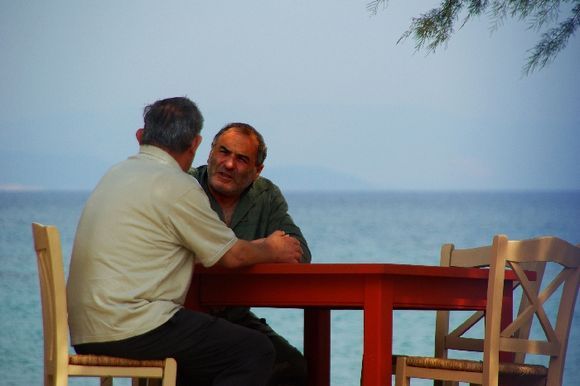 Greek men talking by sea
