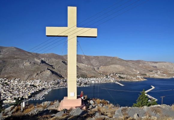 20-09-2014  Kalymnos: The enormous cross nearby the Monastery Agios Savvas with view on Pothia (look at the person to see how big the cross is)